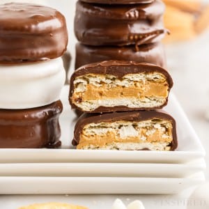 zoomed view of a cut chocolate dipped peanut butter ritz cookies with additional on the side and behind
