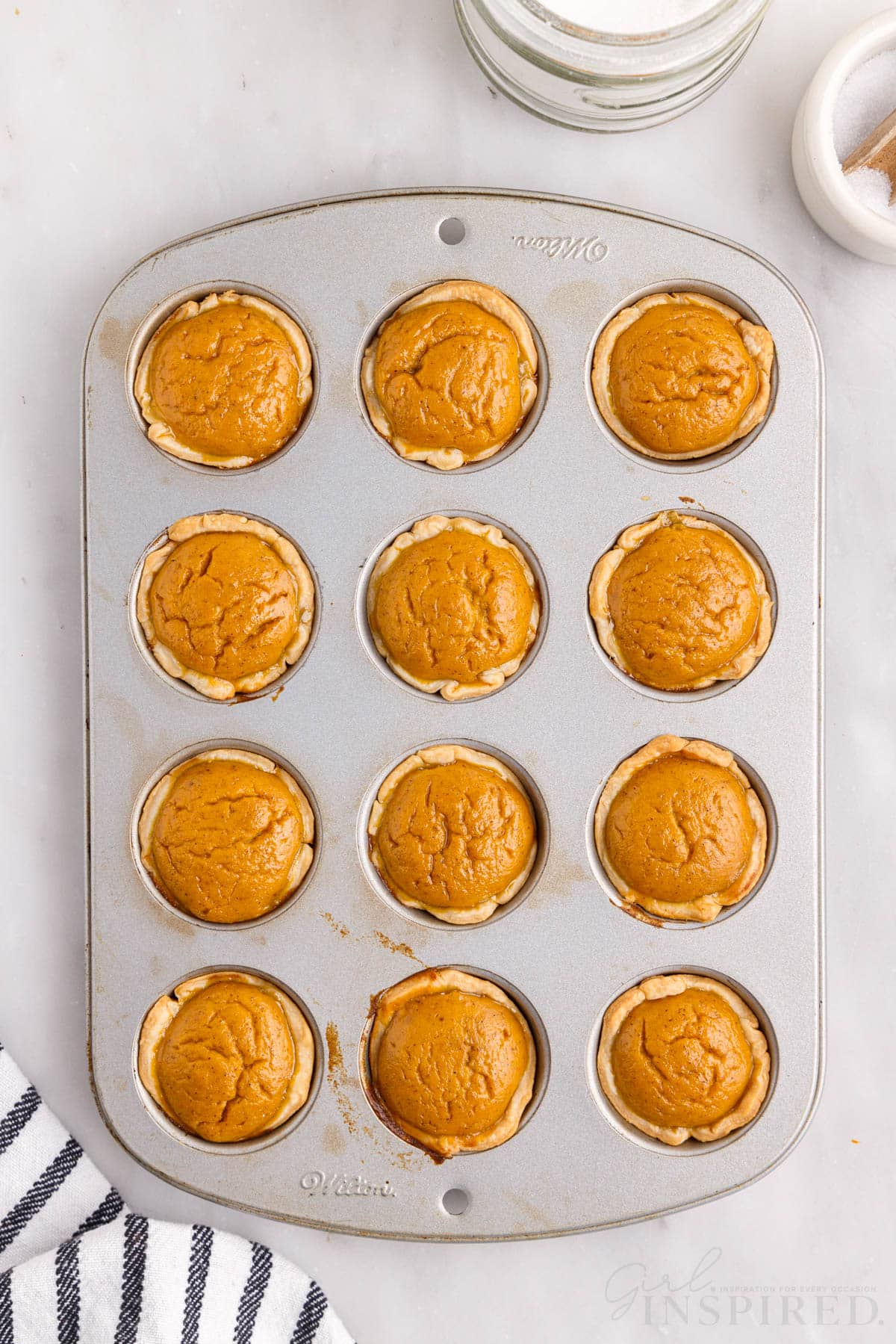 cooked mini pumpkin pie bites in a mini muffin tin