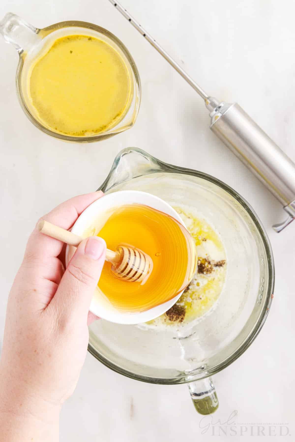 honey in a small bowl poured into large measuring cup with smoked turkey ingredients