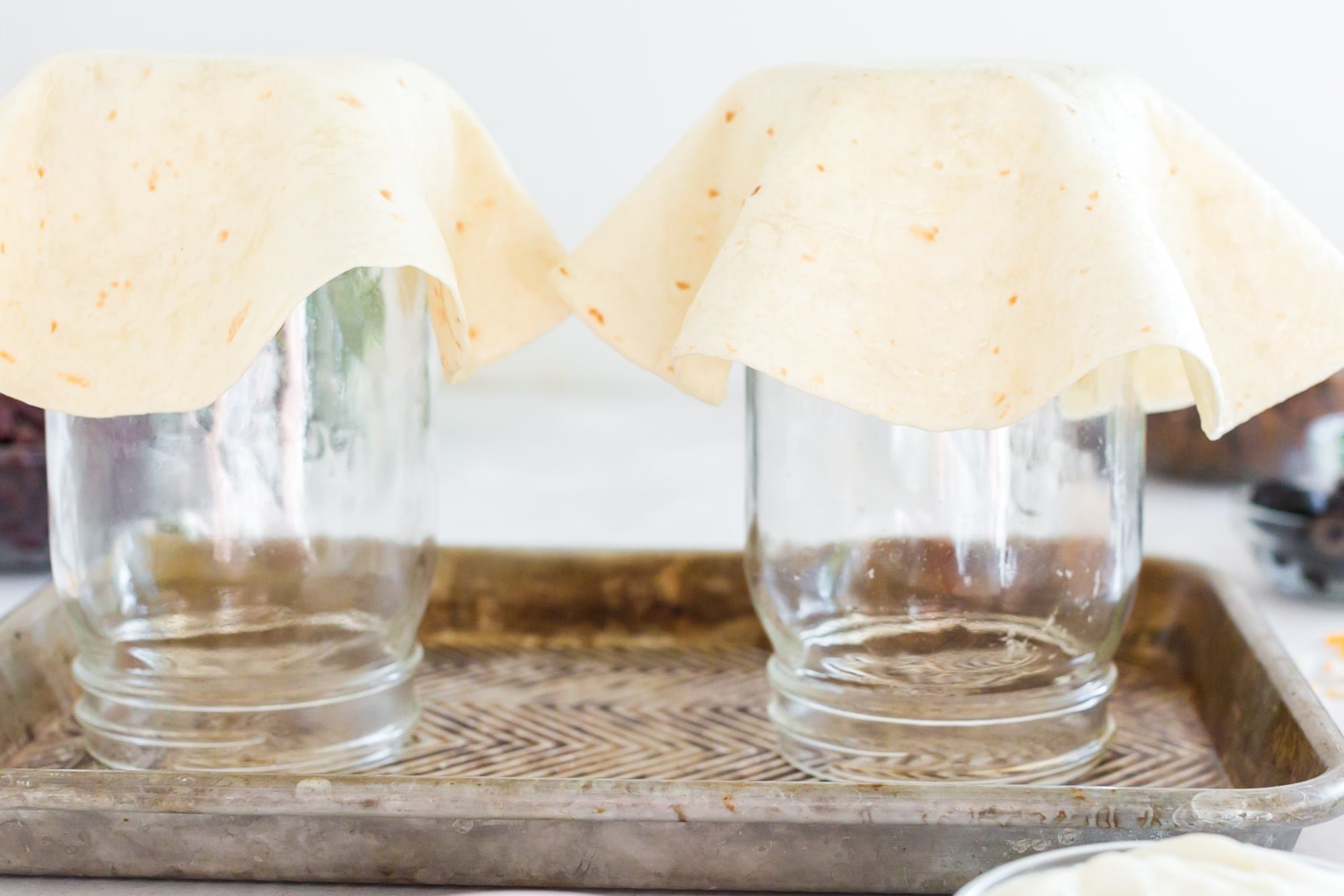 flour tortilla shaped slightly over the upside down mason jars to form tortilla bowl shape.