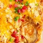 close up of a spoon in turkey enchilada casserole