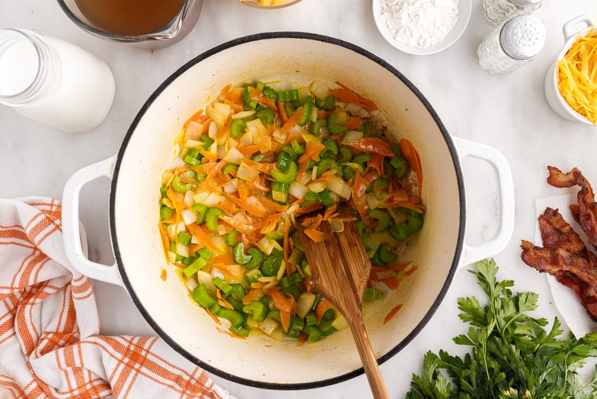 vegetable mixture cooked in stockpot with wooden spoon