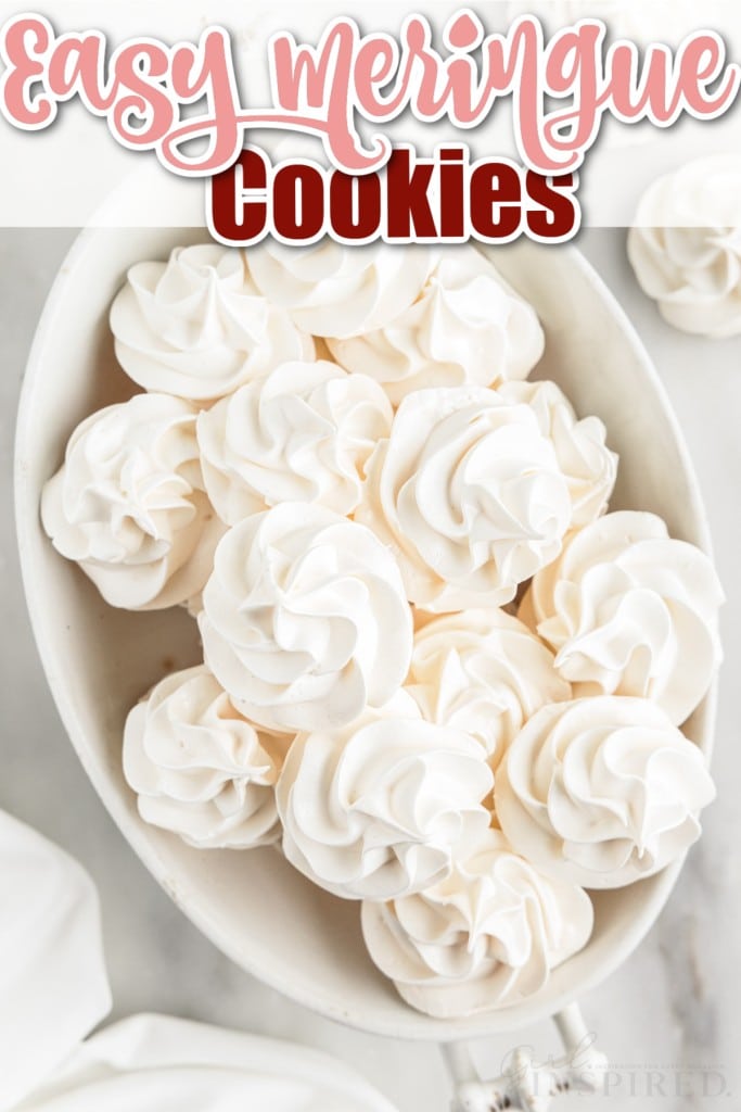 top view of meringue cookies stacked in a white oval serving bowl