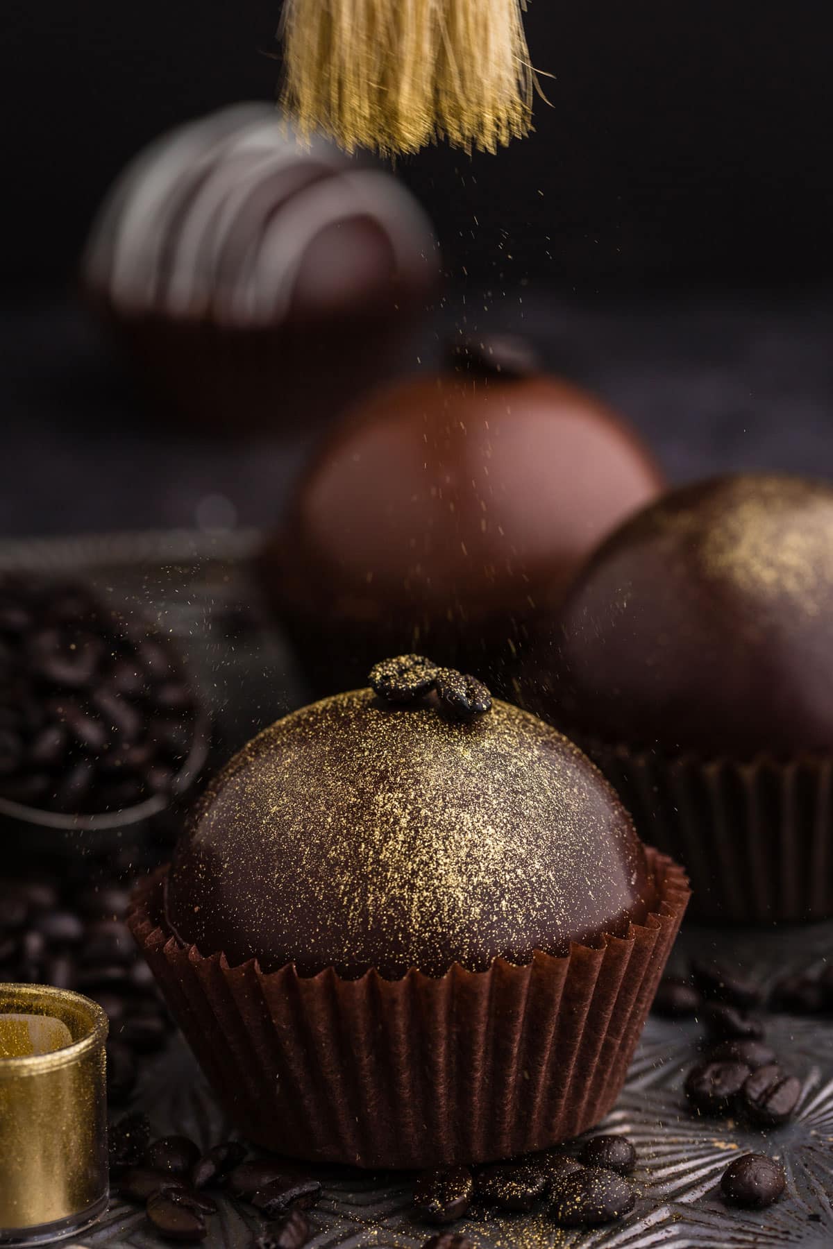 gold edible dust sprinkled on top of mocha hot chocolate bomb