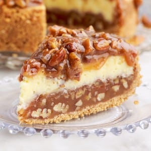 slice of caramel pecan pie cheesecake on a small plate