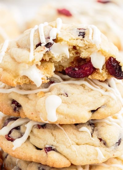 close up of white chocolate cranberry cookies a bite taken from the top one