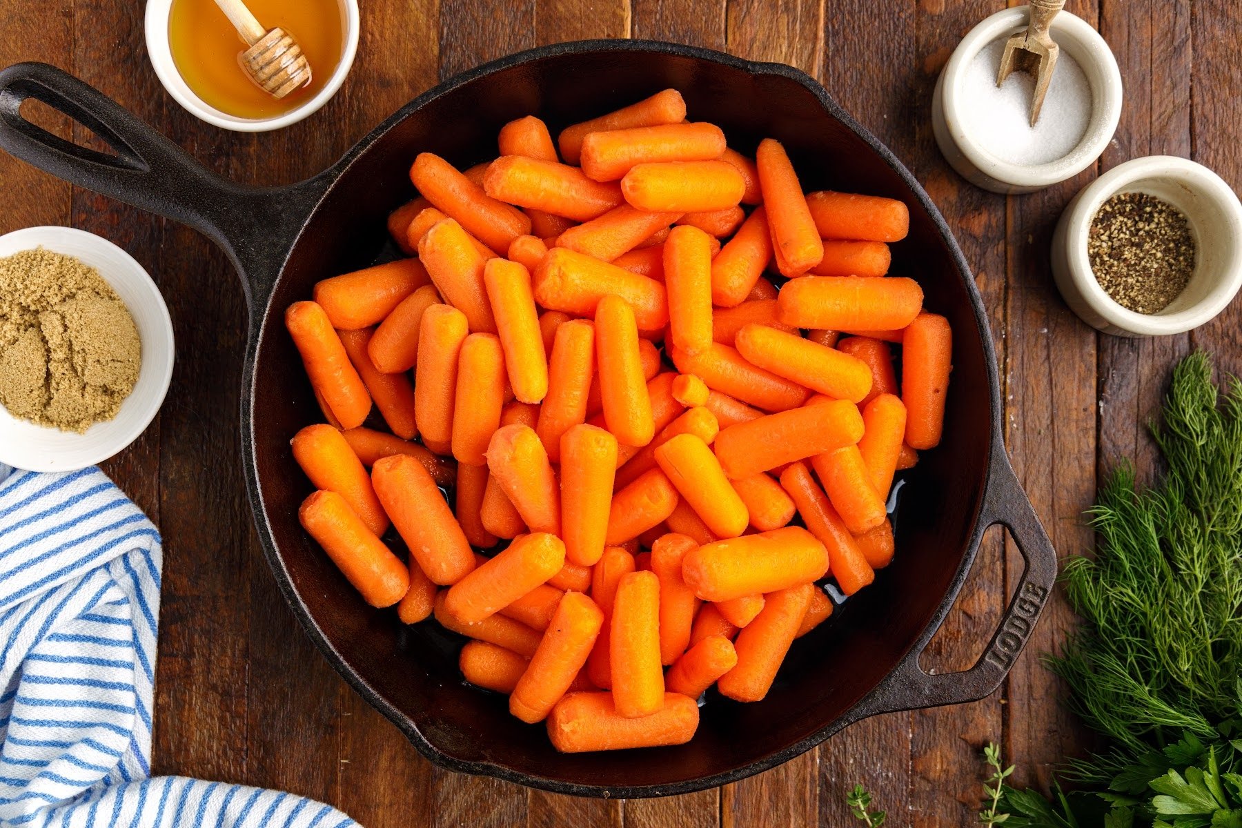 Baby carrots in cast iron skillet with water.