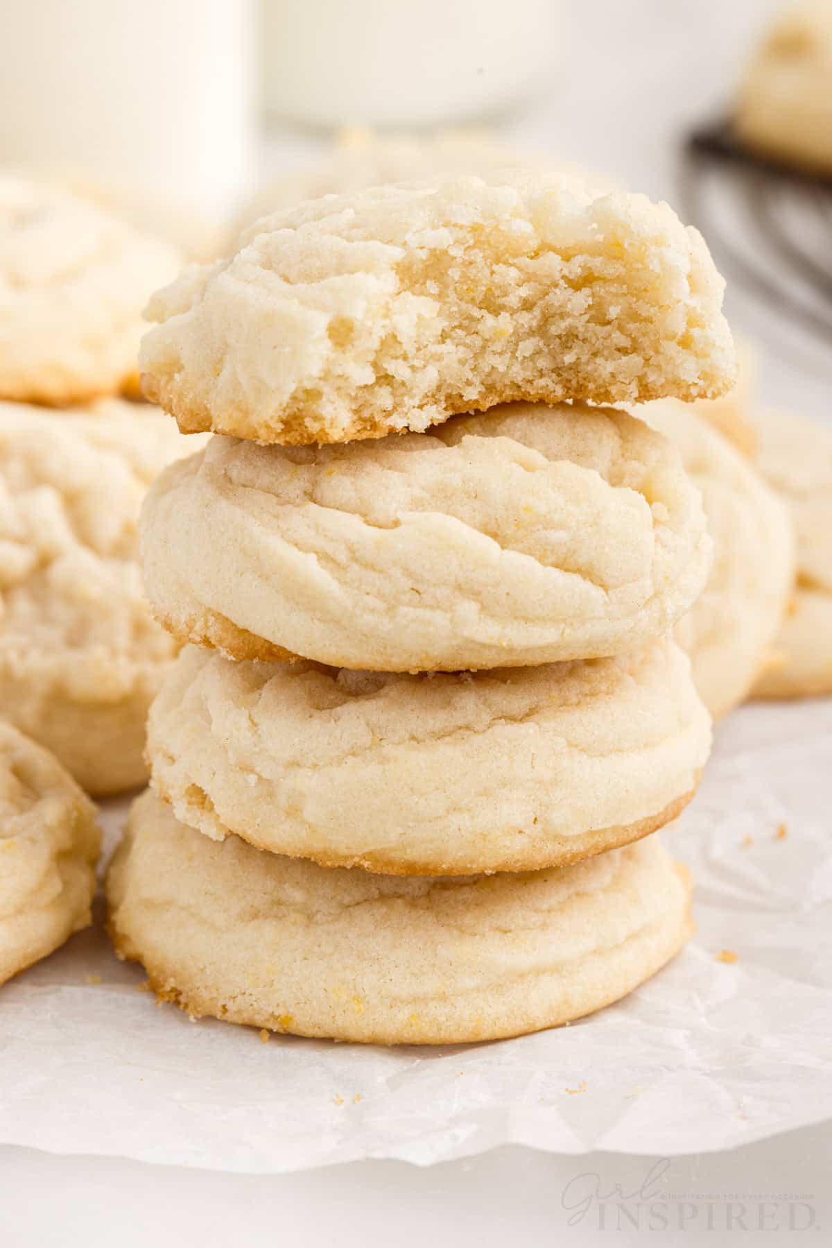 stack of four amish sugar cookies with a bite taken from the top one