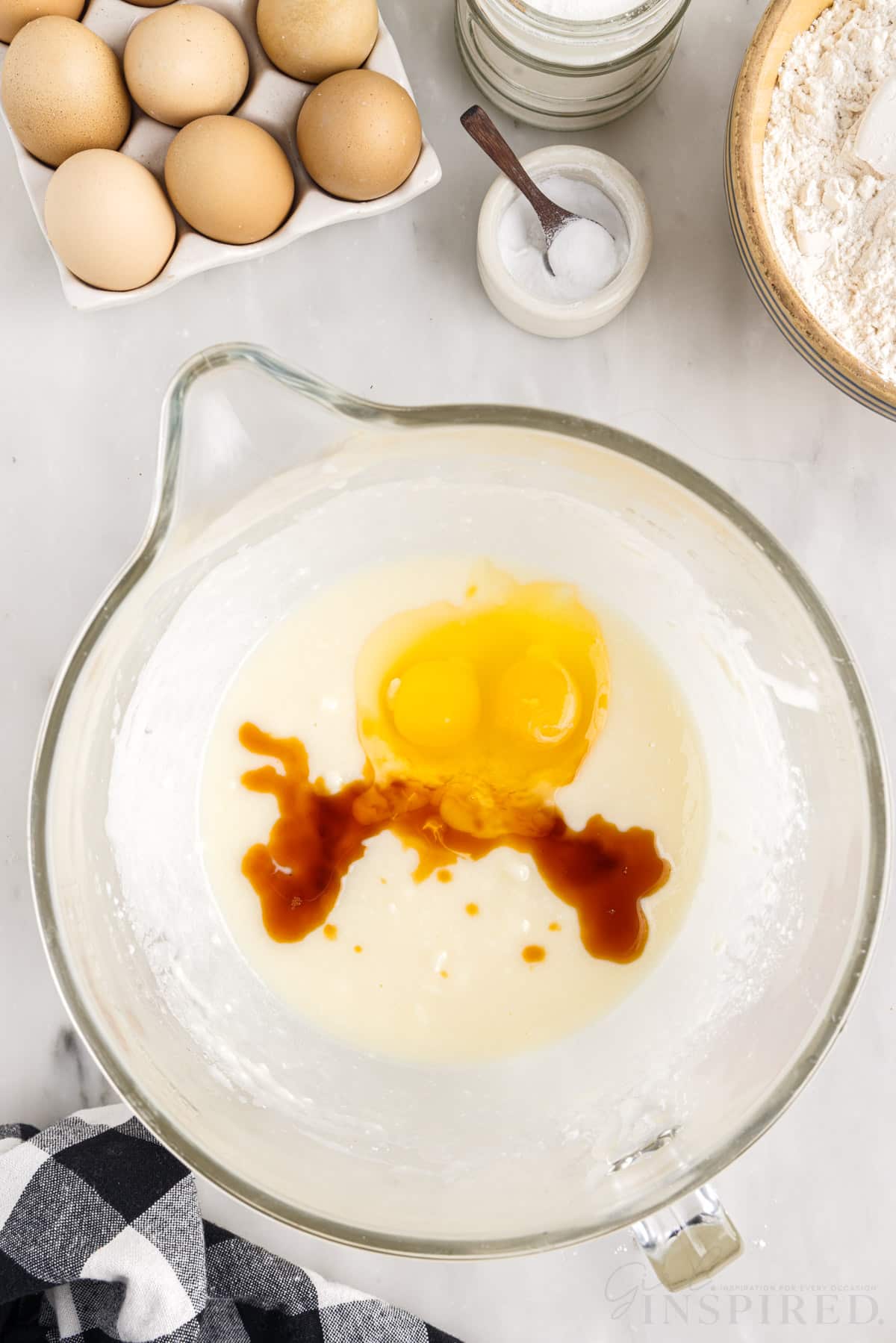 eggs and vanilla added to sugar mixture in a mixing bowl