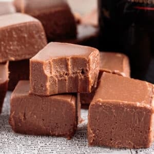 Pyramid stack of Bailey's fudge pieces with bite in top piece.