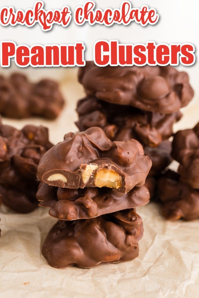 Crockpot Chocolate Peanut Clusters stacked with a bite taken from the top one