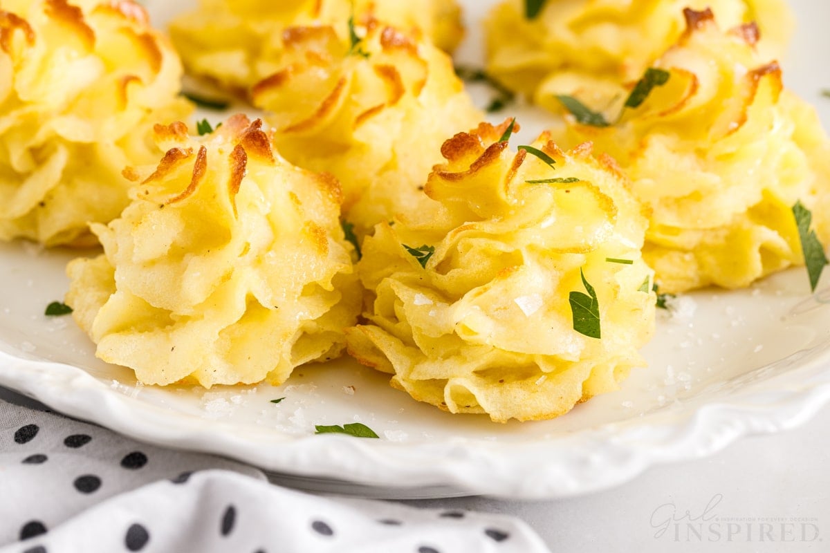 white plate with duchess potatoes