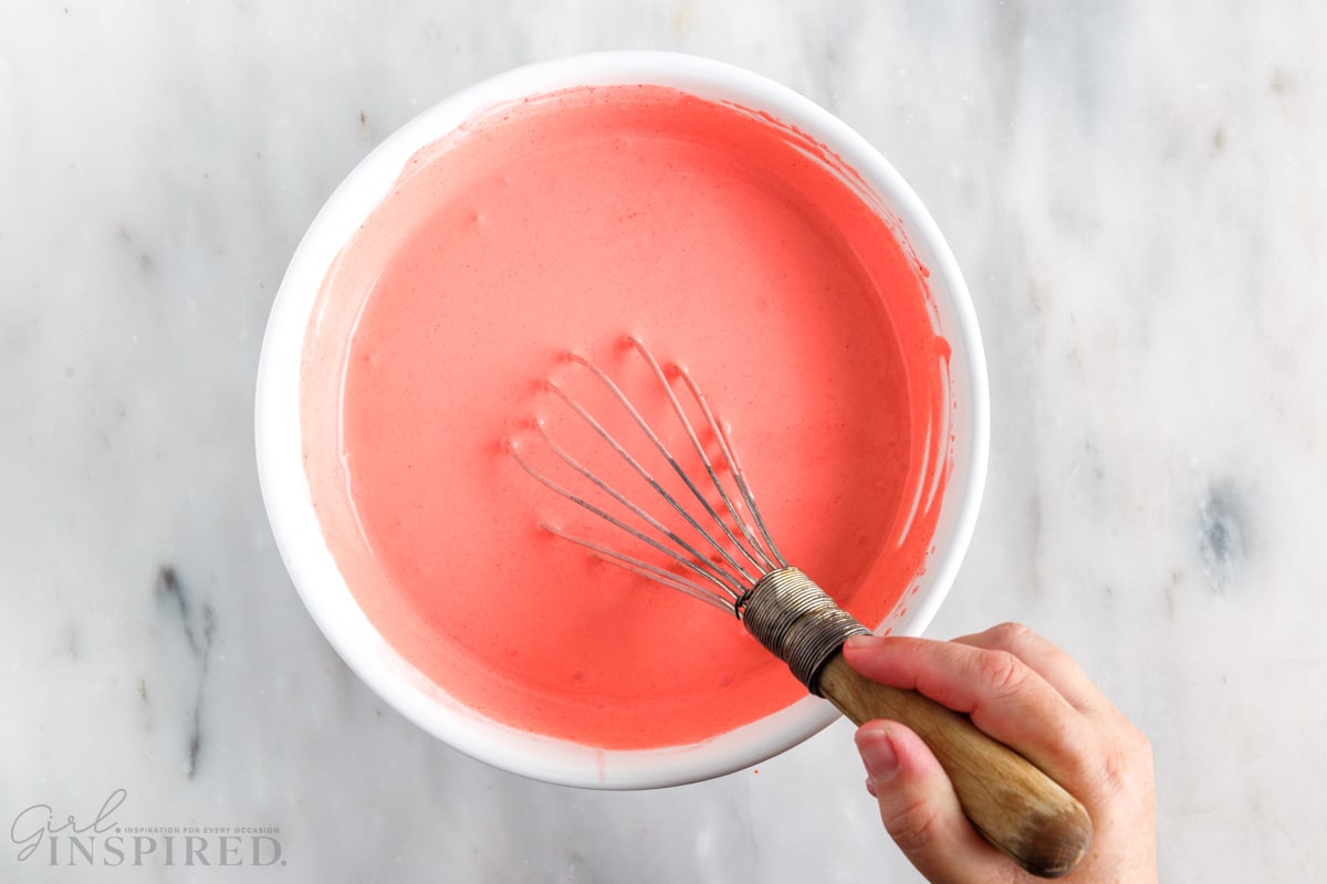 jello cool whip mixture stirred together with a whisk in a mixing bowl