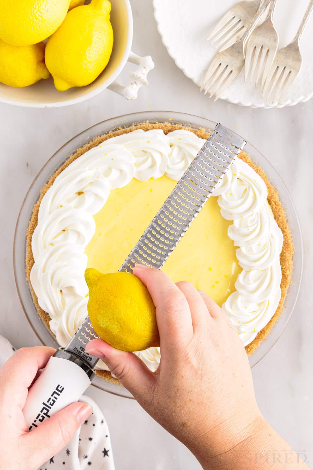 lemon grated with a grater over top lemon cream cheese pie