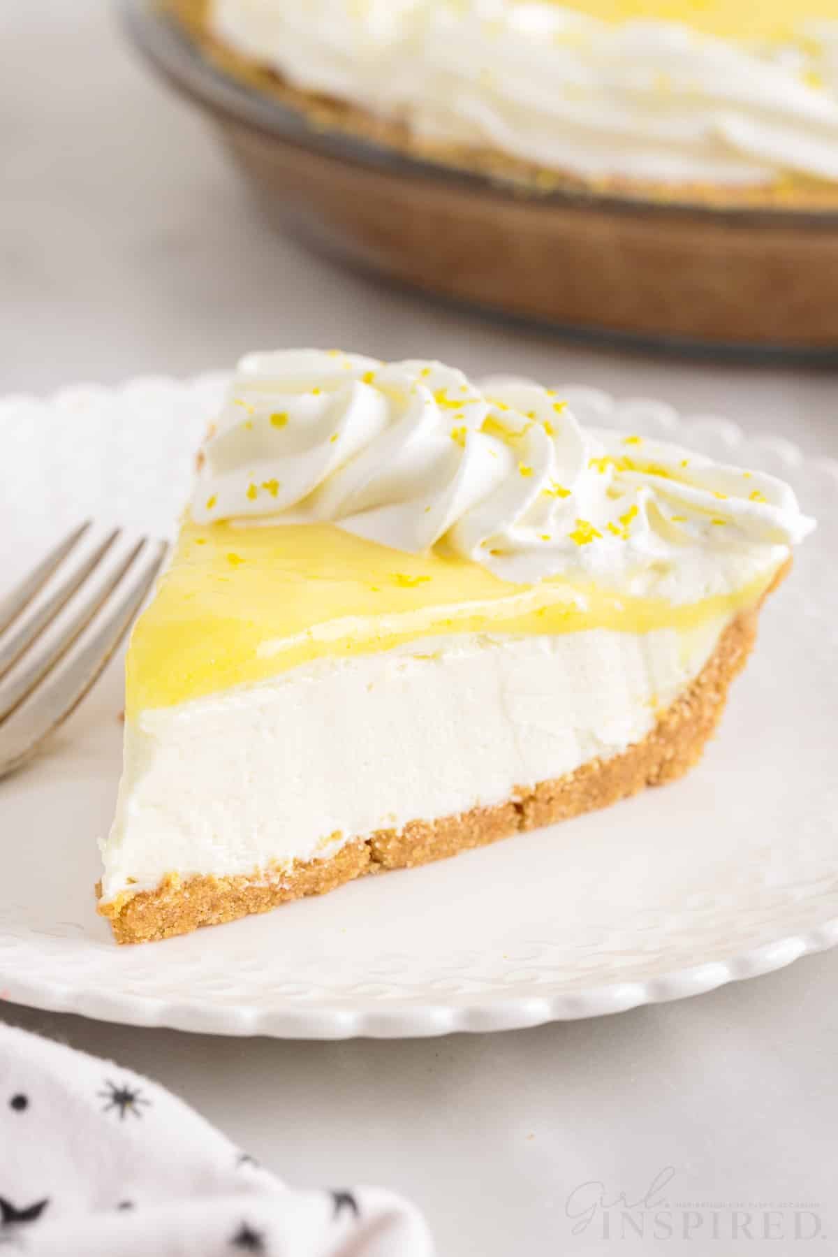 a slice of lemon cream cheese pie on a small plate with a fork