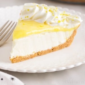 close up of a slice of lemon cream cheese pie on a plate with fork