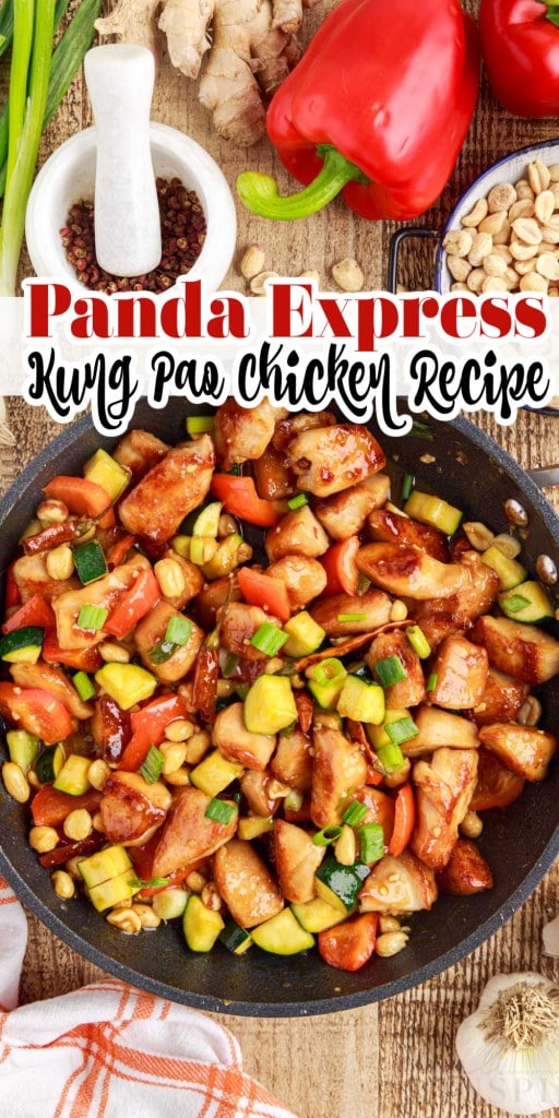 Top view of a skillet full of Panda express kung pao chicken with various condiments and vegetables on a wooden countertop