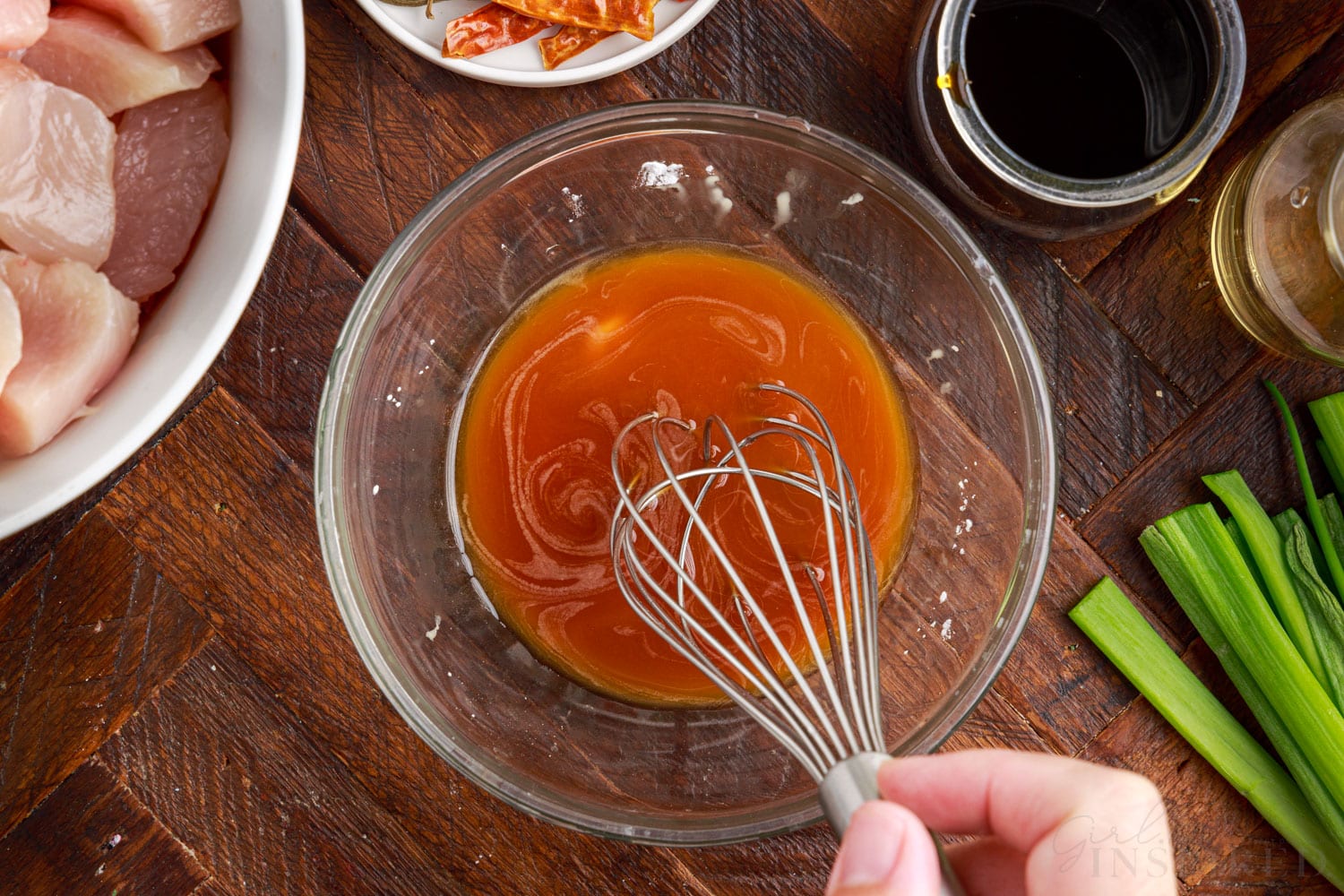 soy sauce and wine mixed together with a whisk in a small glass bowl
