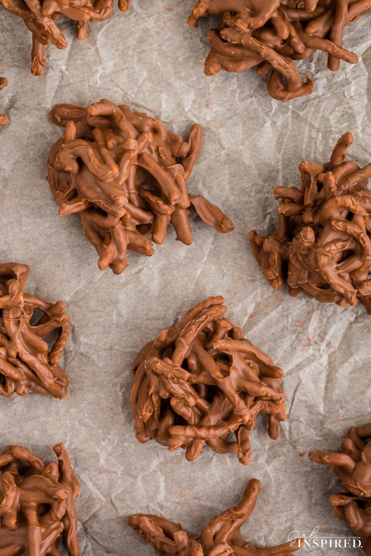 Chocolate butterscotch haystack mounds on parchment paper.