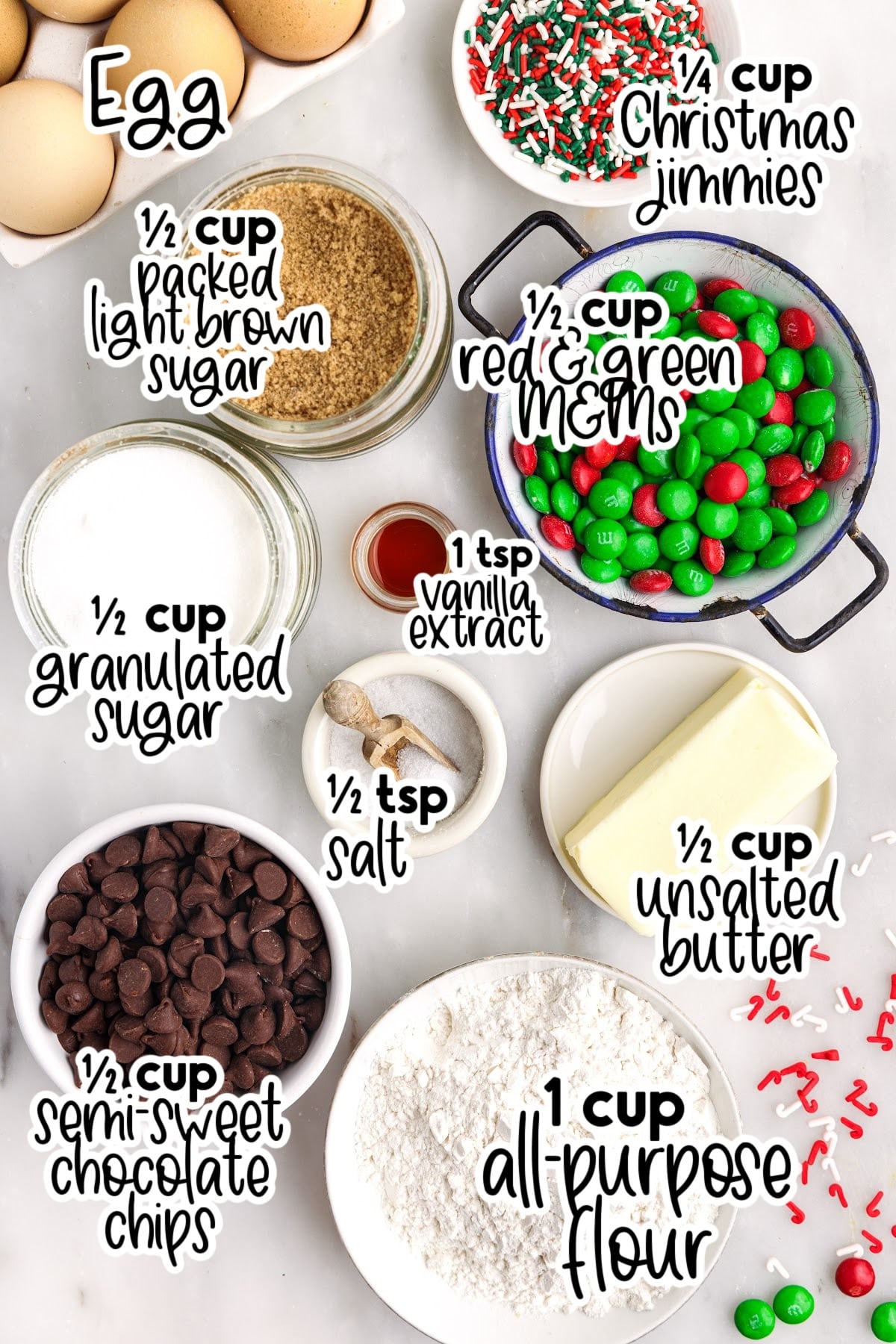 Individual ingredients for Christmas bar cookies set out on plates and bowls with text labels.