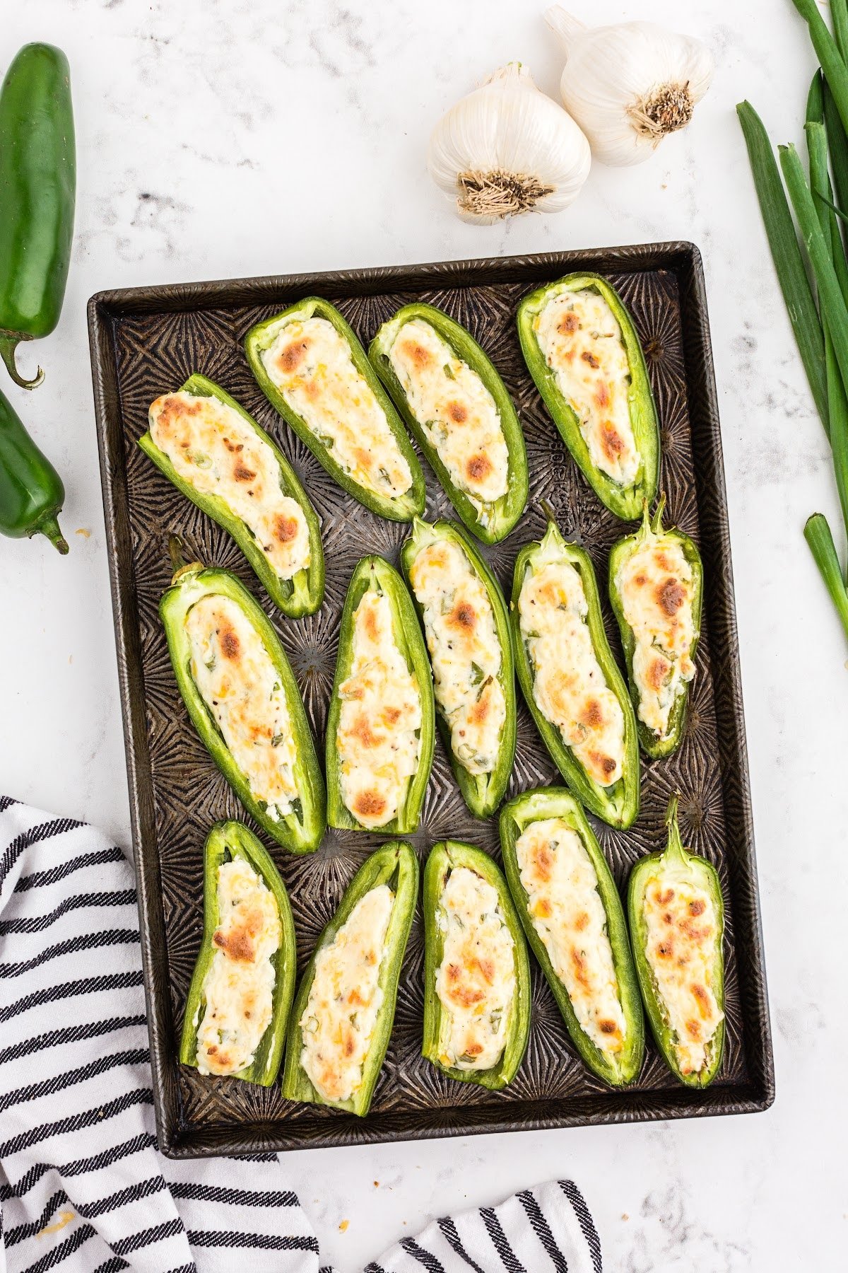 Cooked jalapeño poppers on baking sheet.