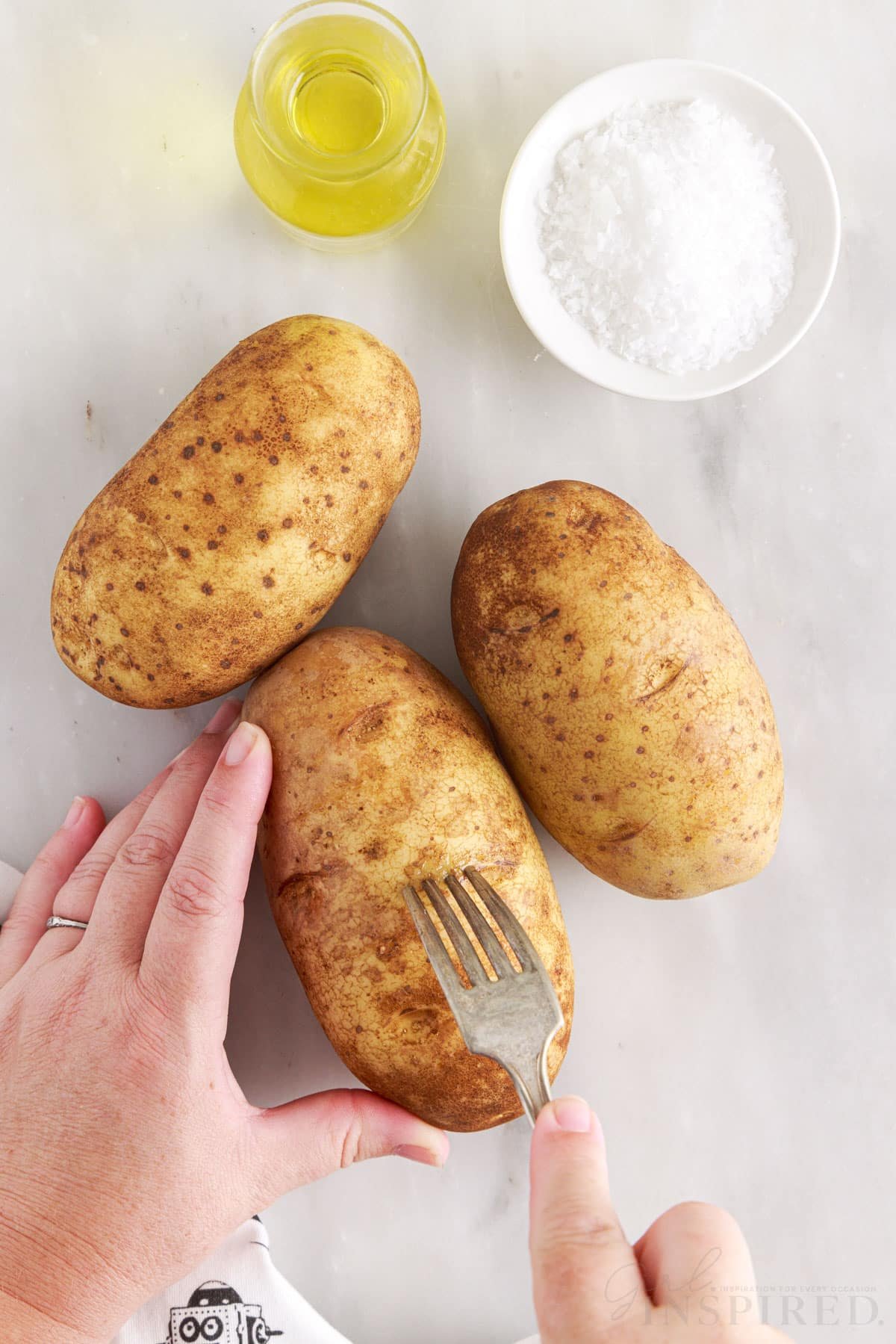 poking holes in the potatoes with a fork