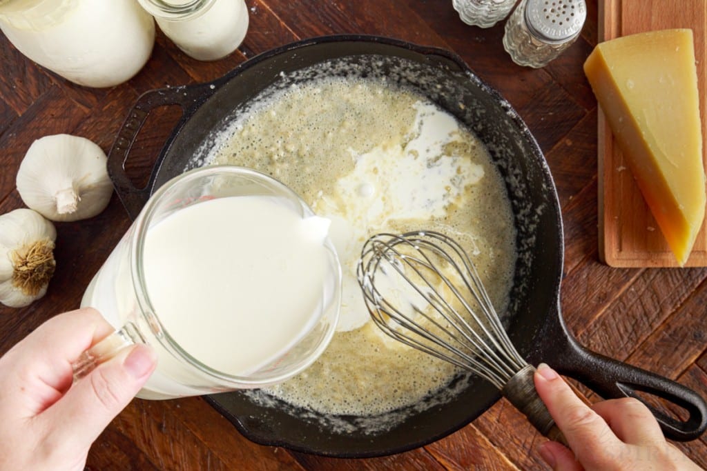 cream added to butter mixture in skillet with whisk