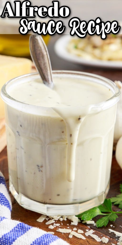 cup with alfredo sauce with spoon inserted