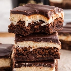 Close up of stacked Baileys brownies, bite taken from top brownie.