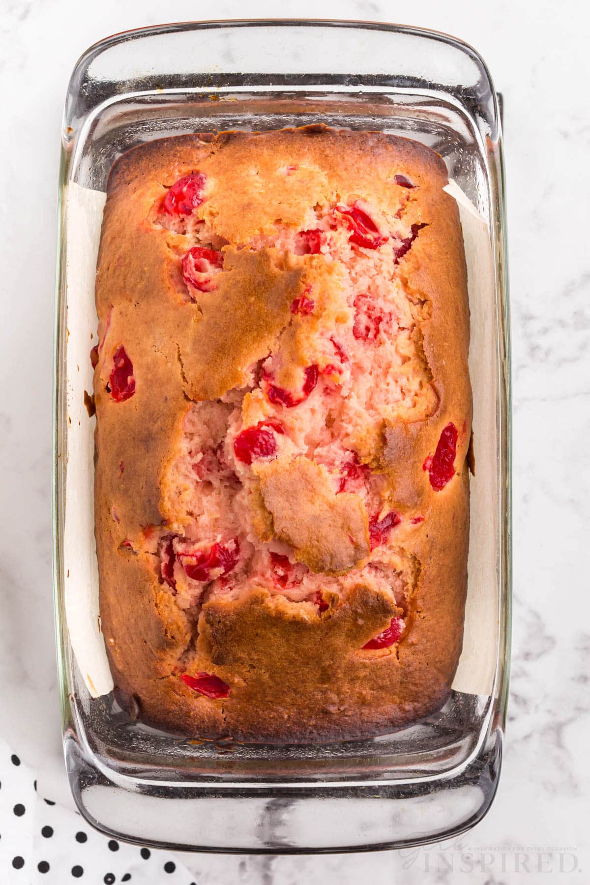 cherry bread after being baked in a glass 9x5 loaf pan