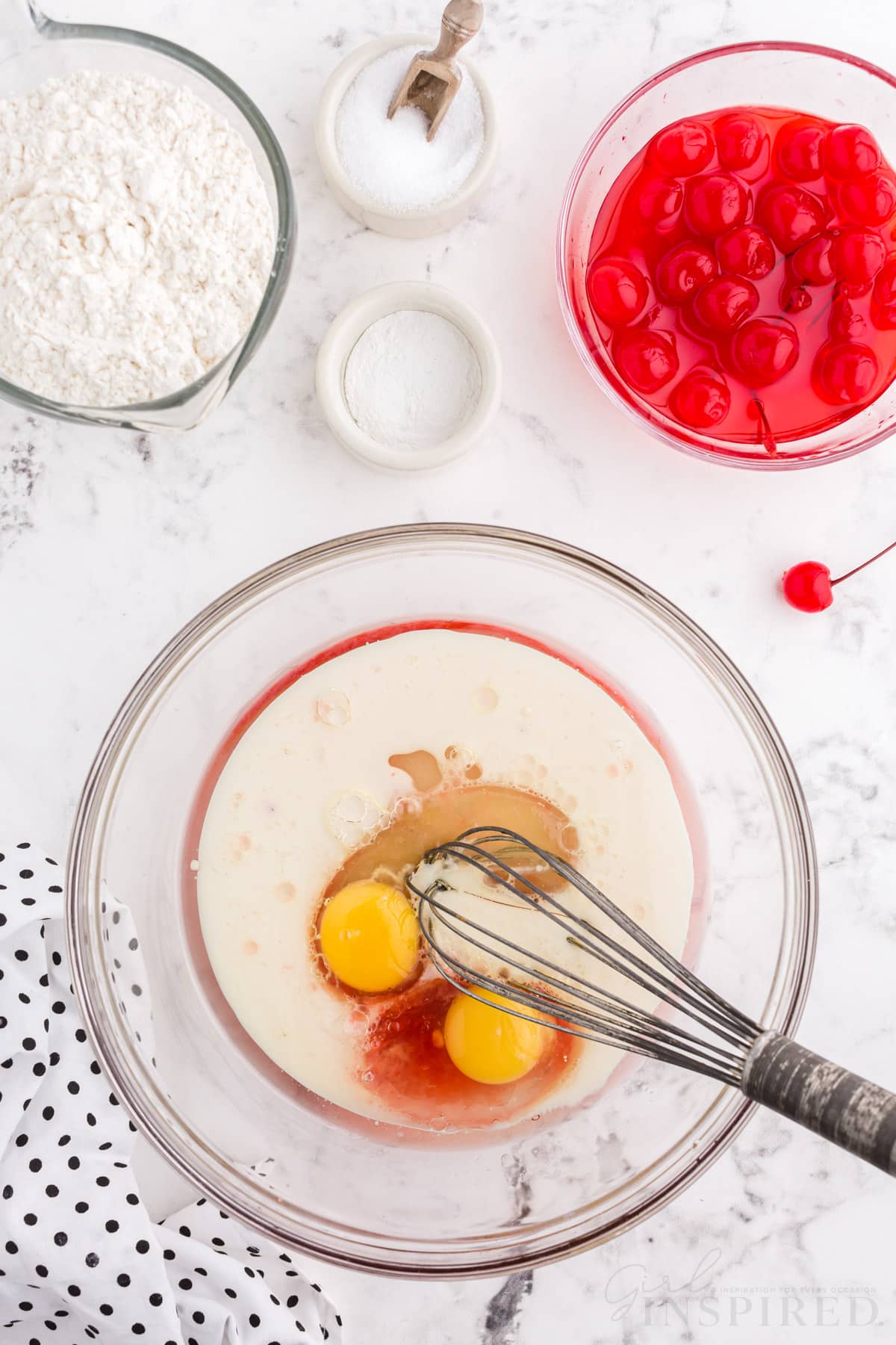 eggs, cherry juice and sugar in a mixing bowl with whisk next to cherries, sugar, and flour for cherry bread