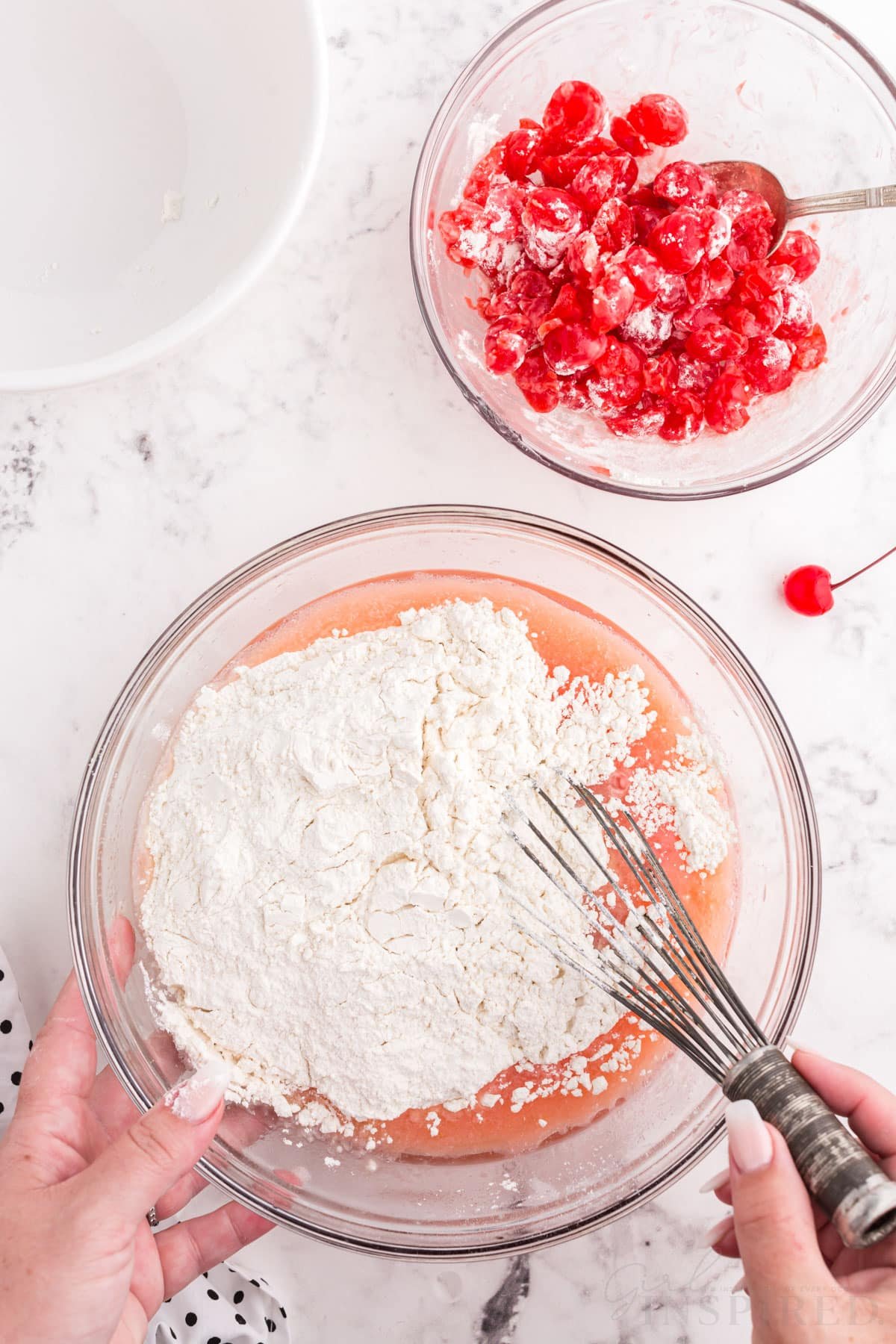 flour added to cherry juice mixture with whisk next to cherry flour mixture