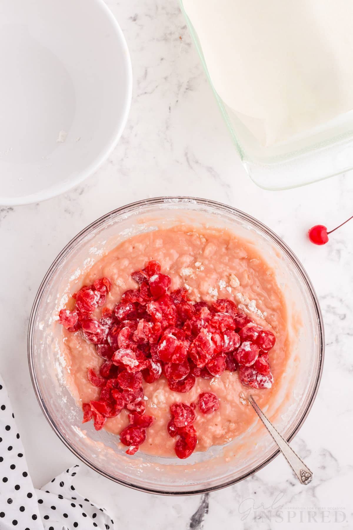 cherries added to cherry juice mixture in bowl for cherry bread