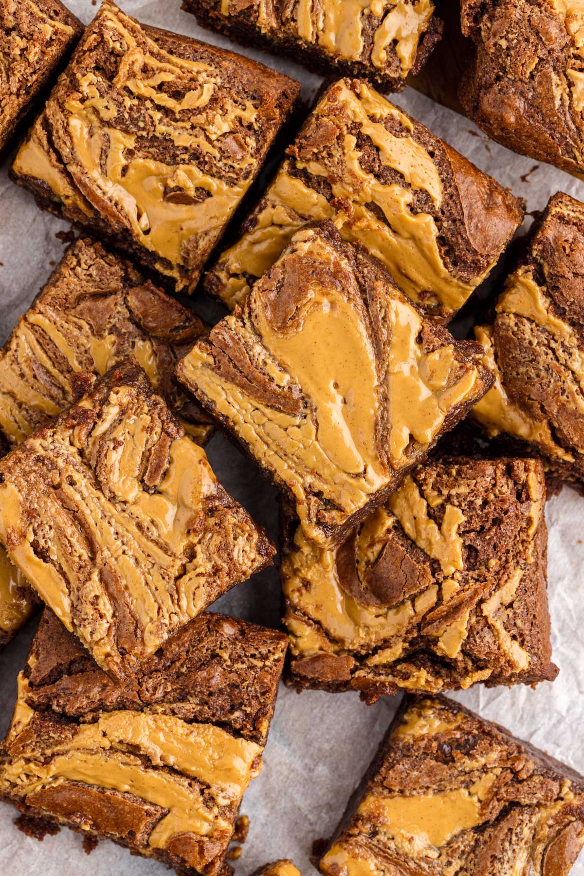 top view of peanut butter brownies cut into squares on parchment paper