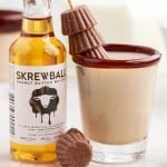 close up of skrewball whiskey reese cup and a mini bottle of skrewball peanut butter whiskey