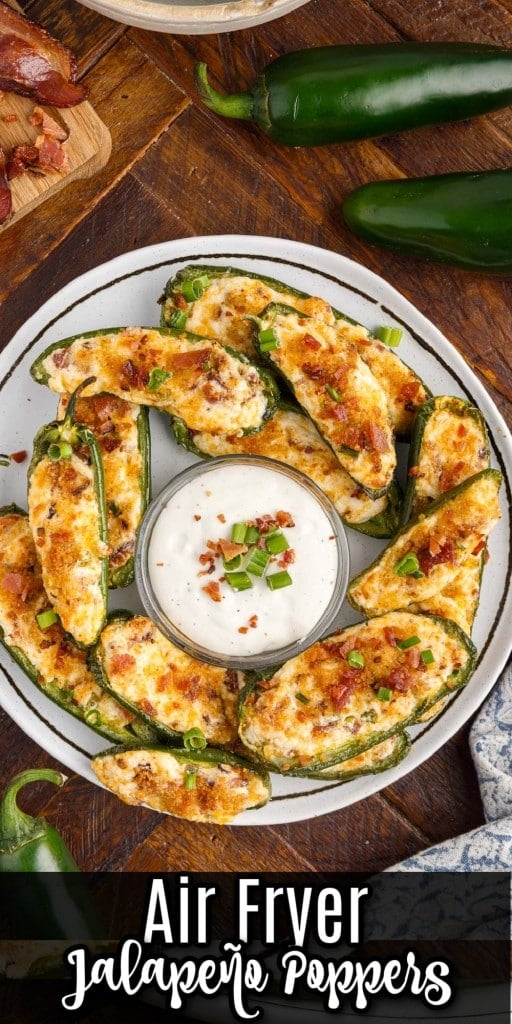 overhead shot of a plate of air fryer stuffed jalapeno poppers with ranch dressing in a dish in the center
