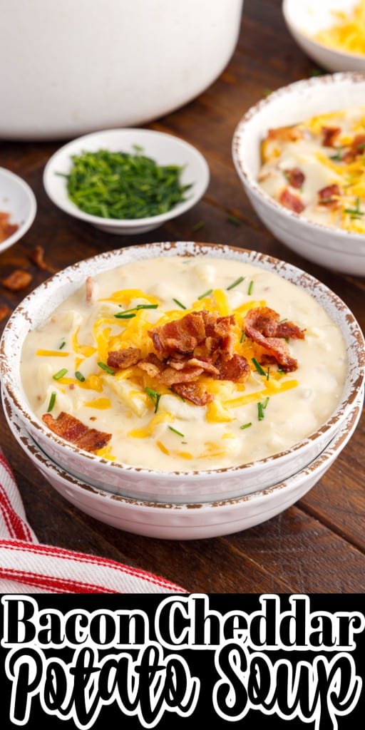 front view of bacon cheddar potato soup in bowls on wooden counter top