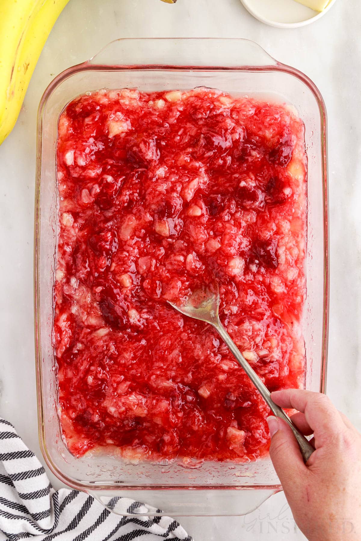 Strawberry pie filling and crushed pineapple mixed together in 9x13 with a spoon.