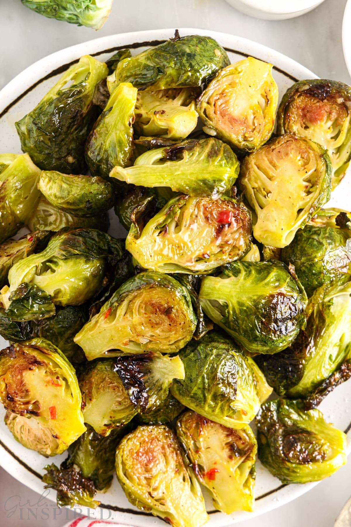 Overhead of Bang Bang Brussel Sprouts on a white plate.