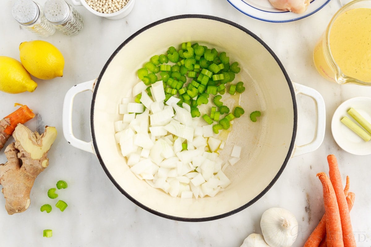 Sauteing onions and celery in melted butter.