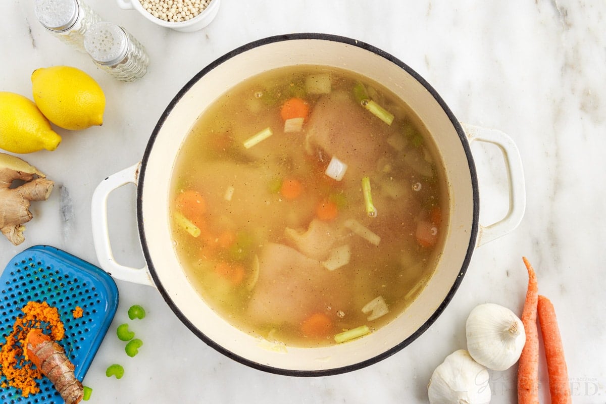 Chicken broth added to other soup ingredients.