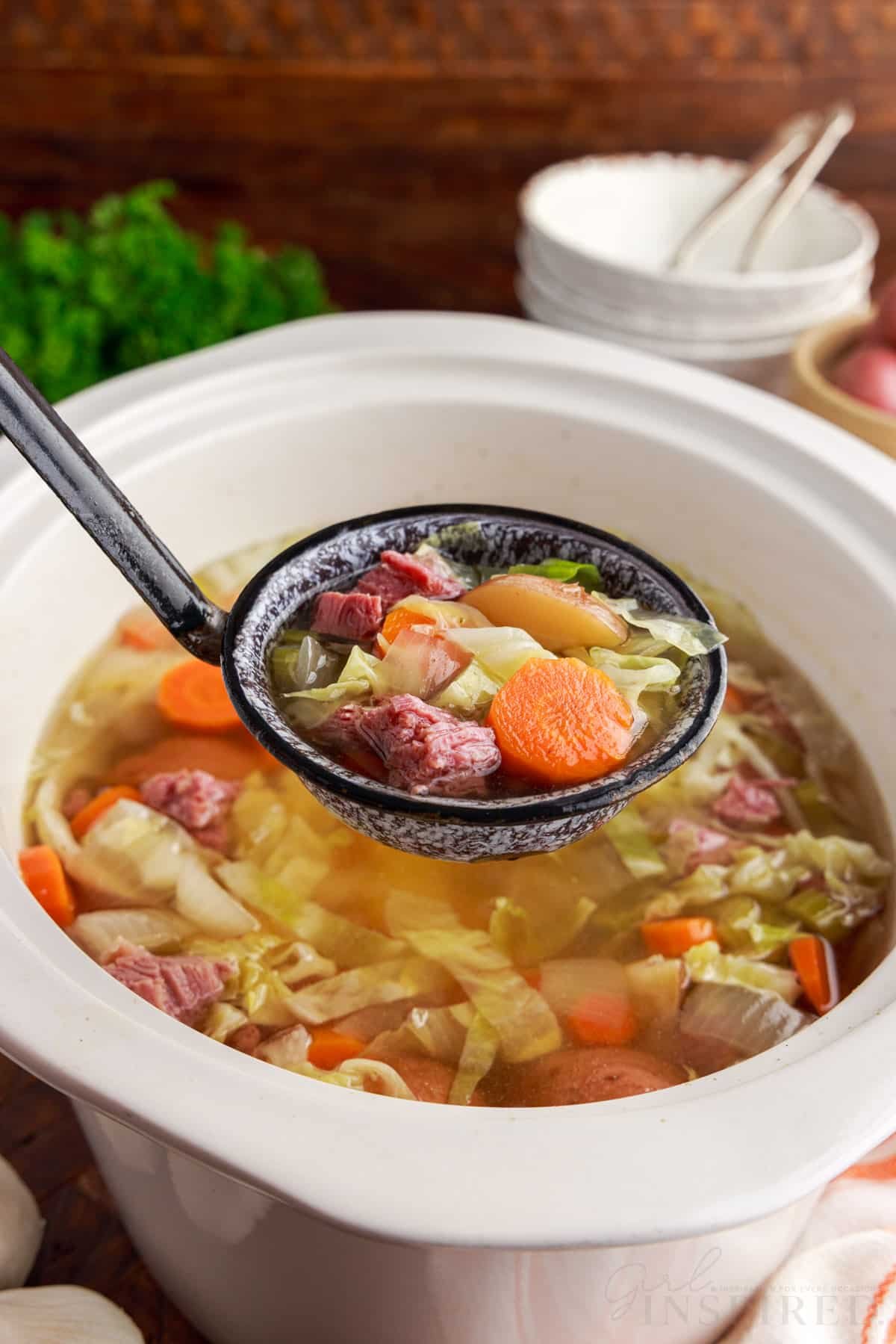 corned beef and cabbage soup on ladle