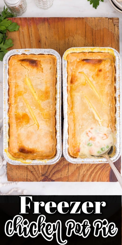 Overhead view of two baked Freezer Chicken Pot Pies resting on a wooden kitchen board.