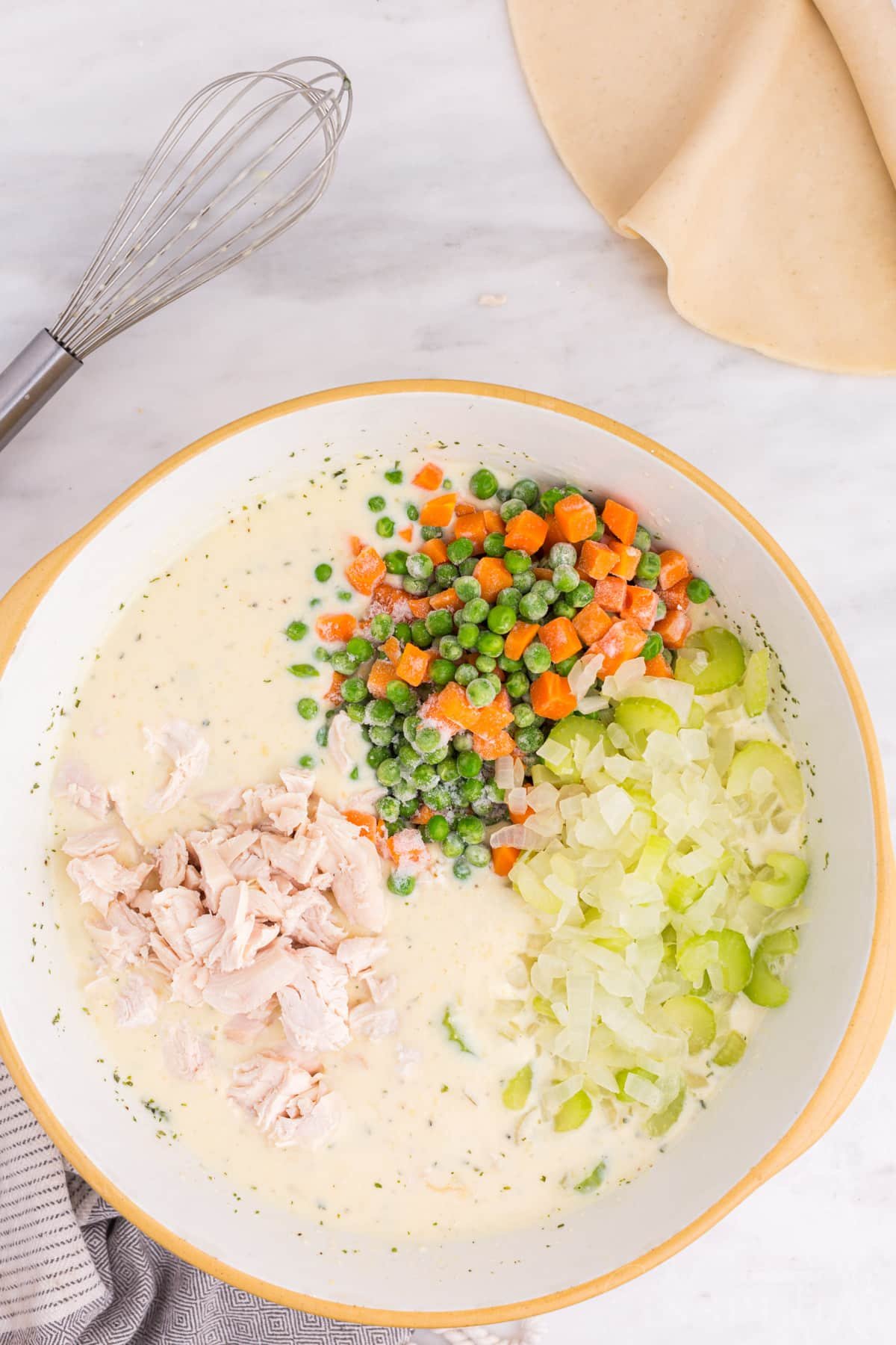 Large mixing bowl with Freezer Chicken Pot Pie filling ingredients.