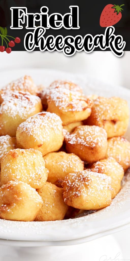 Fried cheesecakes in a bowl drizzled with powdered sugar.