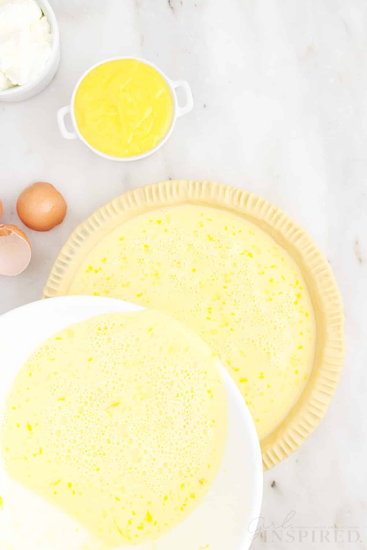 Egg milk mixture poured into a pie crust to make lemon custard pie.
