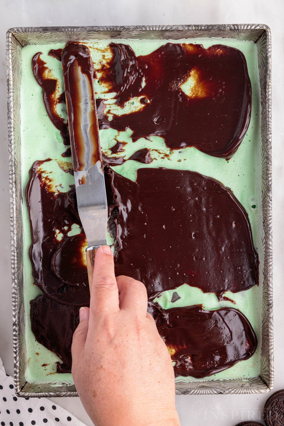 Hot fudge spread onto ice cream layer.