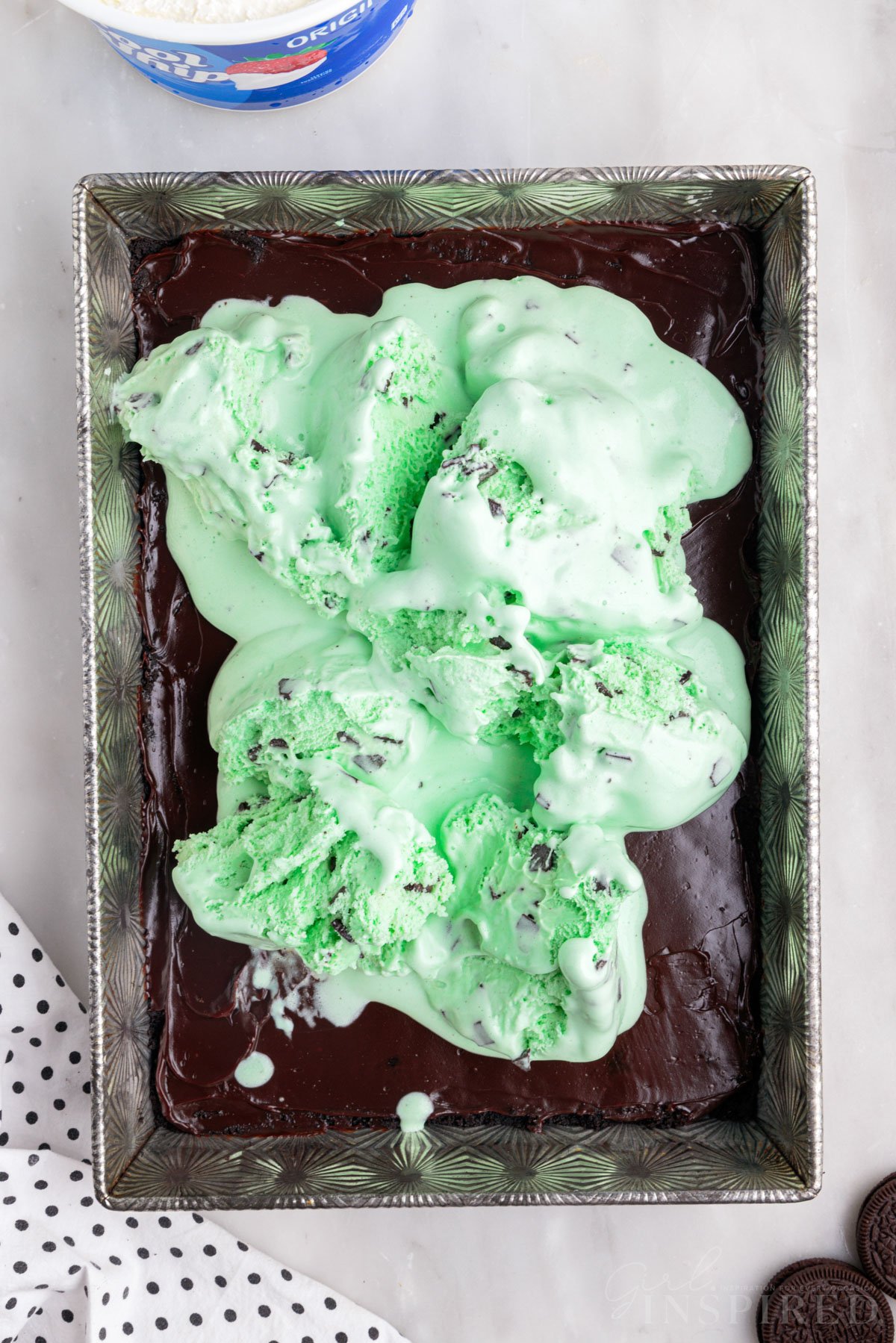 Softened mint chocolate chip ice cream mounded over hot fudge layer.