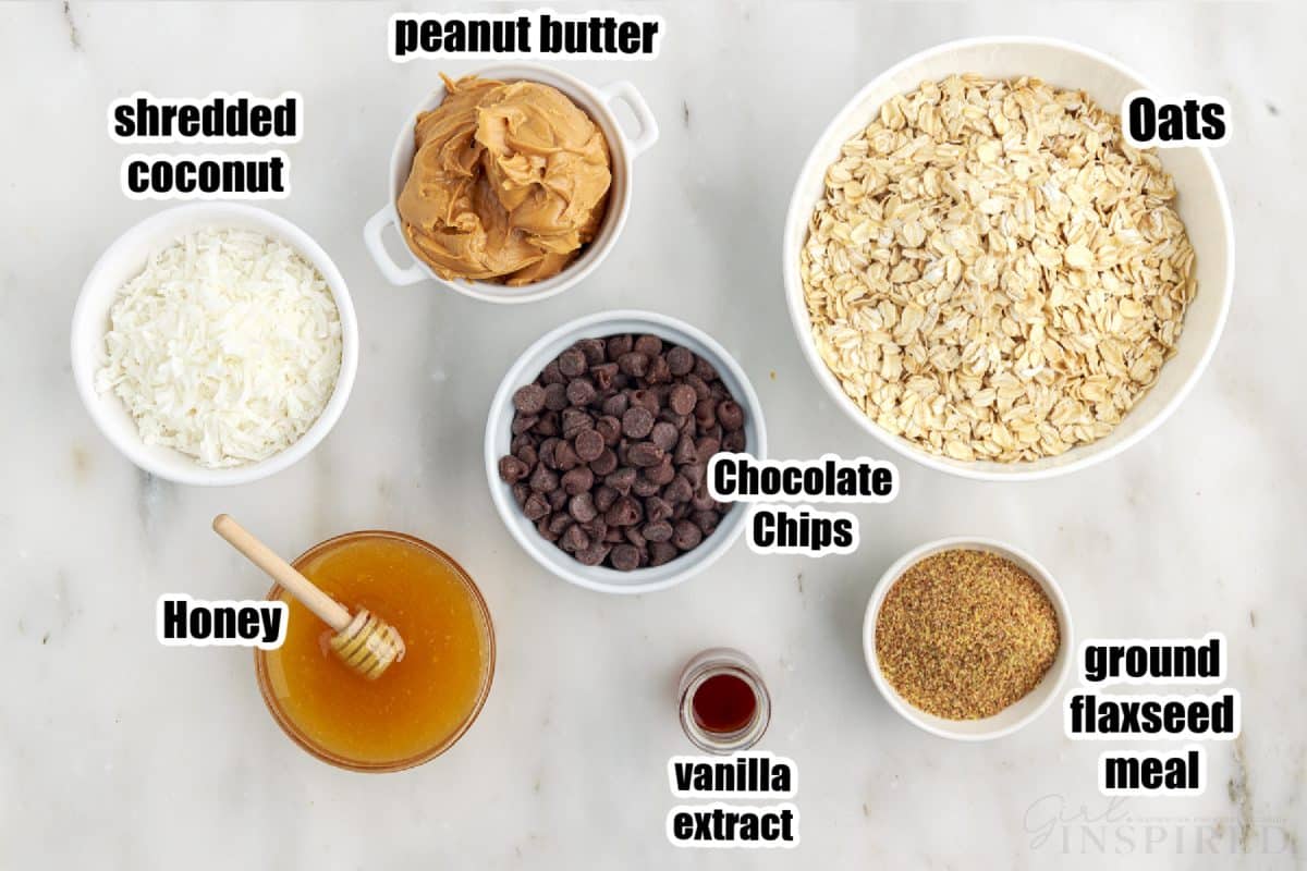 Bowls with individual ingredients for no bake energy balls with text labels.