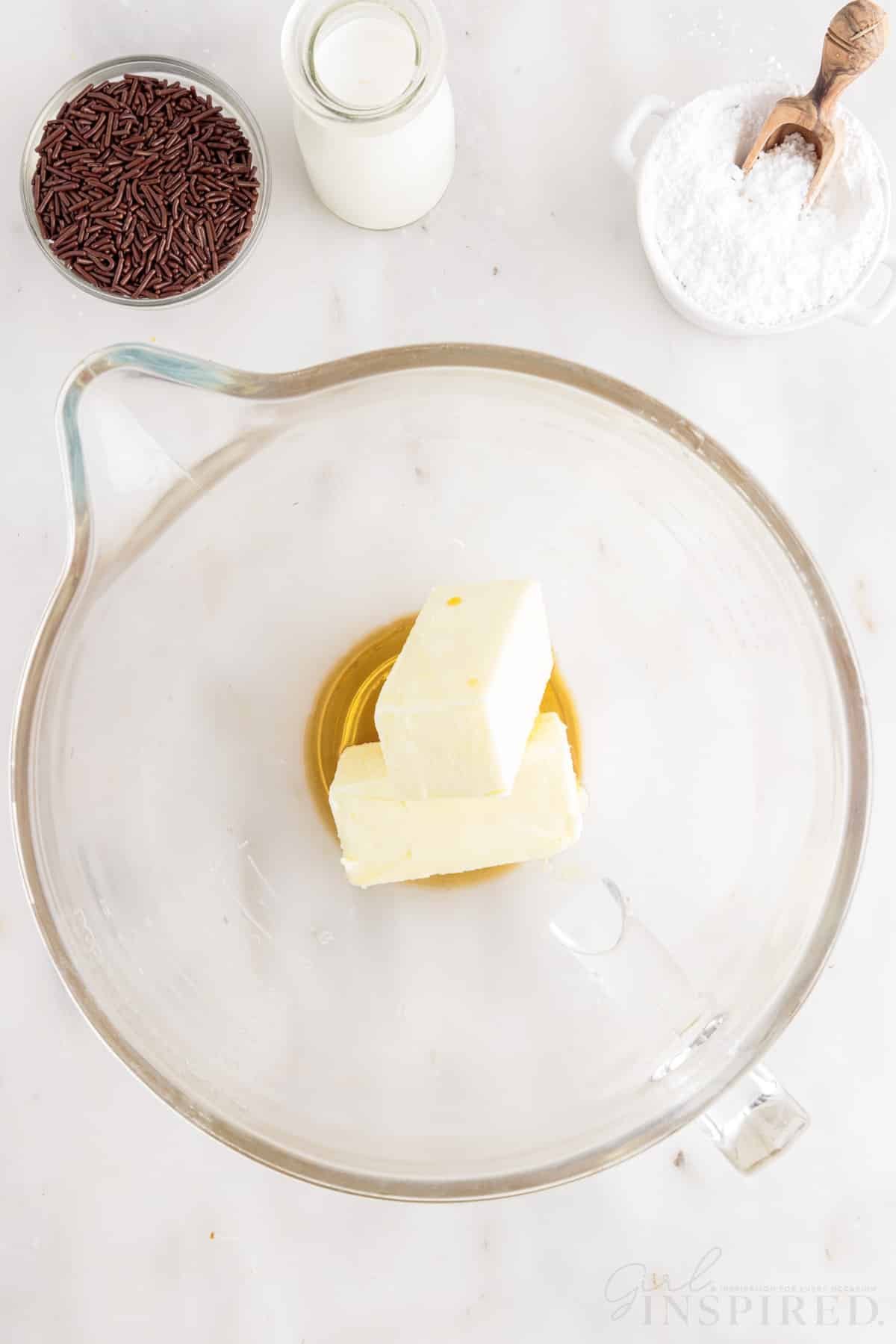 Butter, vanilla, and hazelnut liqueur in mixing bowl for Nutella Cupcake frosting.